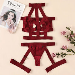 Red lingerie set with a magazine and flowers on a beige background