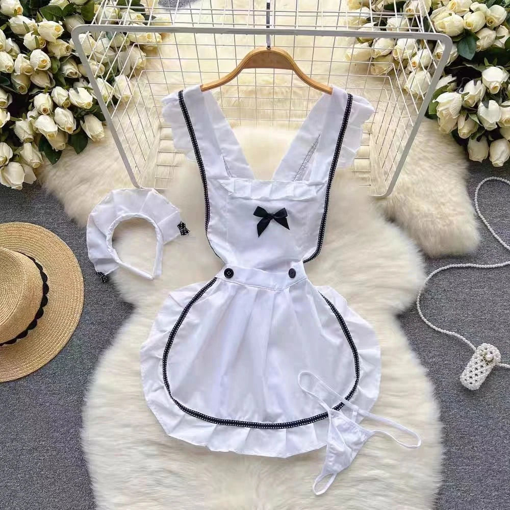 White maid outfit with black details on a hanger against a floral and rug background