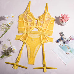 Yellow lingerie set on a stand with flowers and a magazine in the background