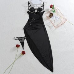Black dress with matching bra and panties on a white surface with red roses.