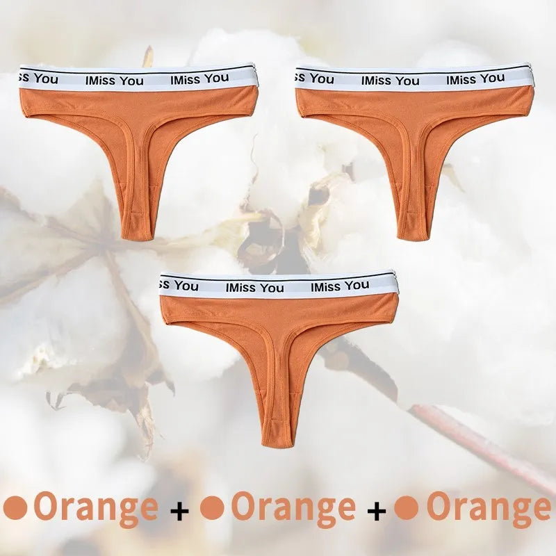 Three pairs of orange men's underwear with 'I Miss You' waistband on a light background.