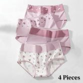Set of three pairs of pink and white underwear with heart patterns on a light gray background