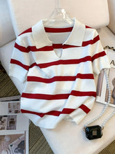 Red and white striped sweater on a mannequin with a neutral background