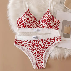 Red leopard print bra and panties set on a fur surface with 'Fashion' label.
