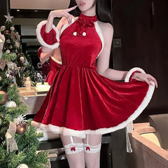 Person wearing a red dress with white trim in a festive indoor setting.