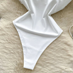 White fabric draped over a textured beige surface