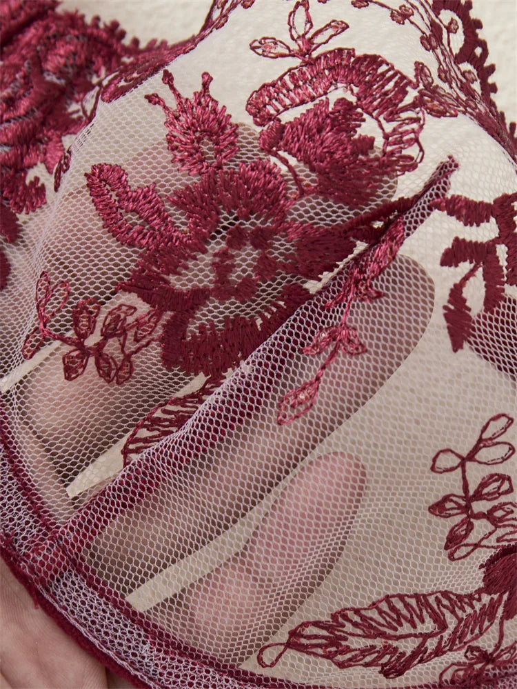 Close-up of red floral lace fabric on a beige background