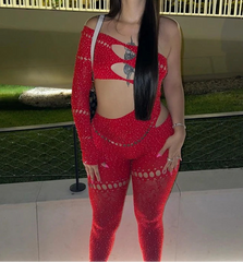 Woman wearing a red outfit with cut-out design in an outdoor setting