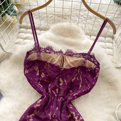 Purple lace lingerie set on a hanger against a white fur background