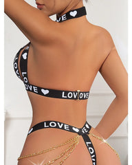 Black 'LOVE' printed bikini set with gold chains on a white background