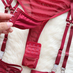 Red lingerie set with straps on a white surface