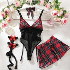 Black and red plaid lingerie set with matching skirt on a white surface with floral decorations.