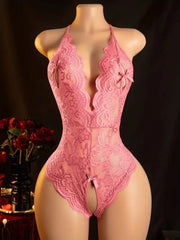 Pink lace lingerie on a mannequin against a dark background