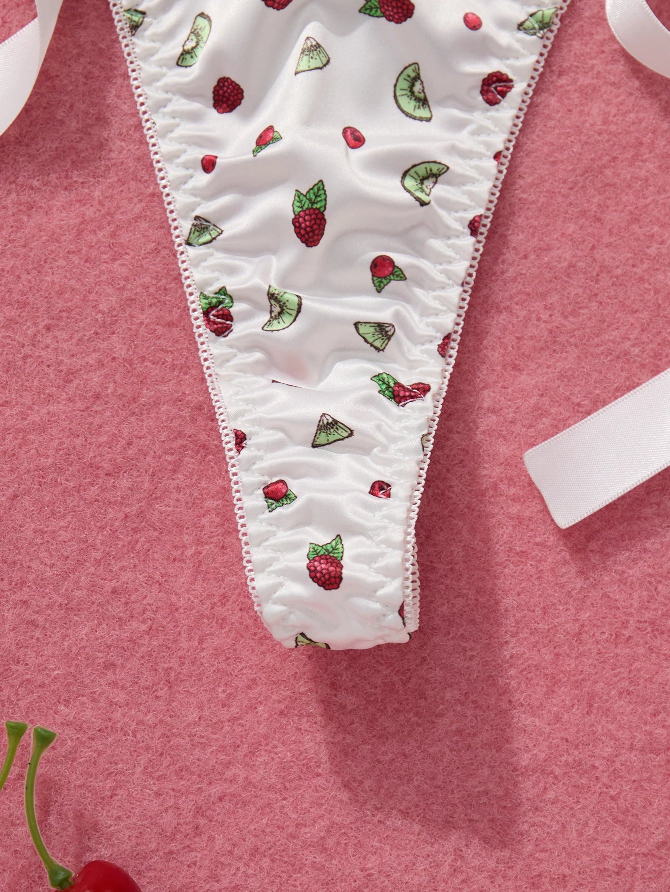 White underwear with fruit pattern on a pink background