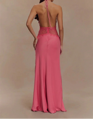 Woman wearing a pink evening gown with a backless design on a beige background
