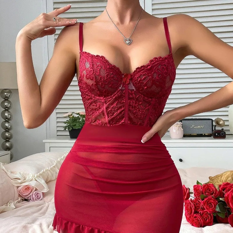 Red lace lingerie set worn by a model in a bedroom setting with flowers and decor.