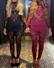 Two women wearing lace outfits standing side by side in a room with patterned floor.