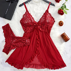 Red lace lingerie set on a white surface with decorative items.