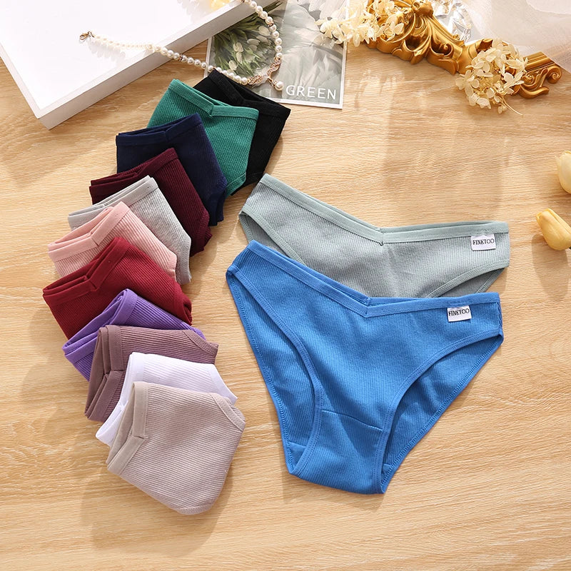 Assorted colors of men's underwear on a wooden surface with a brand label visible.