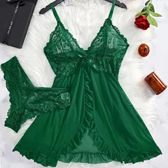 Green lace lingerie set on a white surface with decorative items.