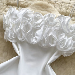 White dress with ruffled neckline on a mannequin against a neutral background