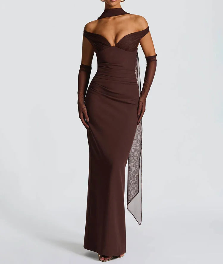 Woman wearing a brown off-shoulder evening gown with a sheer panel on a white background