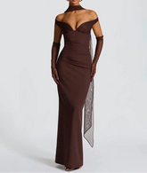 Woman wearing a brown off-shoulder evening gown with a sheer panel on a white background