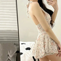 Woman wearing a floral dress in a bedroom setting