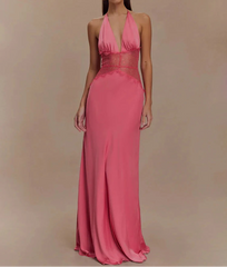 Woman wearing a pink evening gown against a beige background