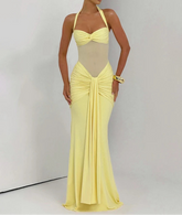 Woman wearing a yellow evening gown against a plain background