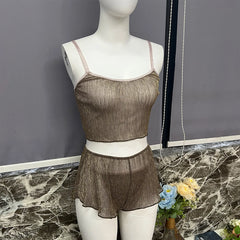 Mannequin wearing a brown lace lingerie set on a marble surface with a gray wall background.