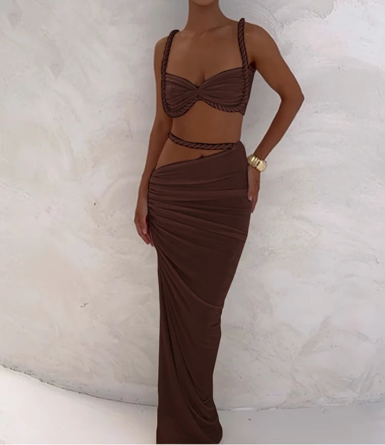 Woman wearing a brown two-piece outfit against a white background