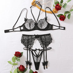 Black lace lingerie set with roses on a white background