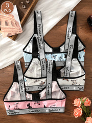 Set of three children's aprons with 'Sweet' branding on a wooden surface.