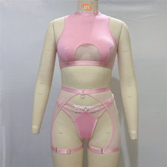 Pink lingerie set on a mannequin against a gray background