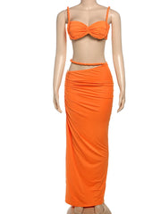 Mannequin wearing an orange bikini set with a matching skirt on a white background