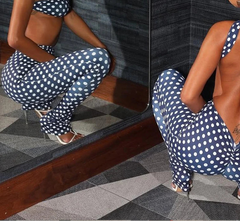 Woman in a polka dot outfit posing in front of a mirror.