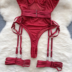 Red lingerie set with straps on a white fur surface