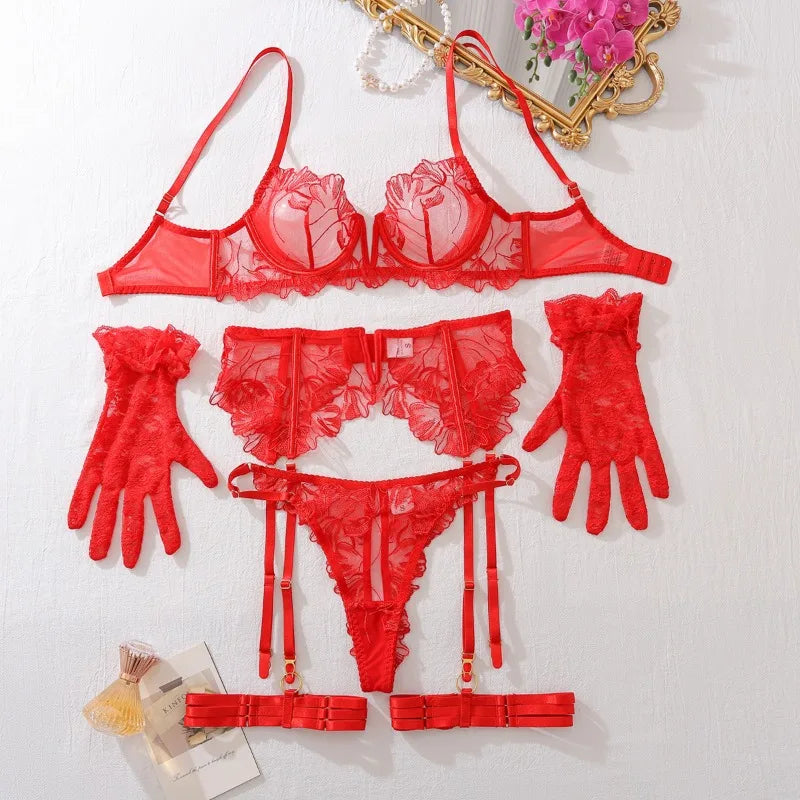 Red lace lingerie set with matching garter belt and gloves on a white background.
