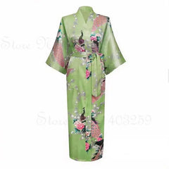 Green kimono with floral and bird patterns on a white background