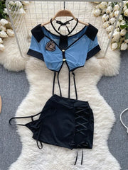 Blue and black two-piece outfit on a hanger with flowers in the background