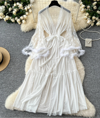 White lace dress on a hanger with decorative elements on a gray surface