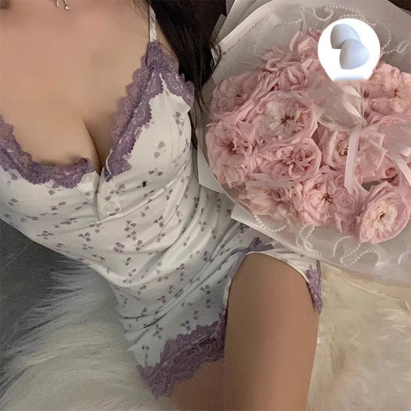 Person wearing a white and purple lace outfit holding pink flowers.