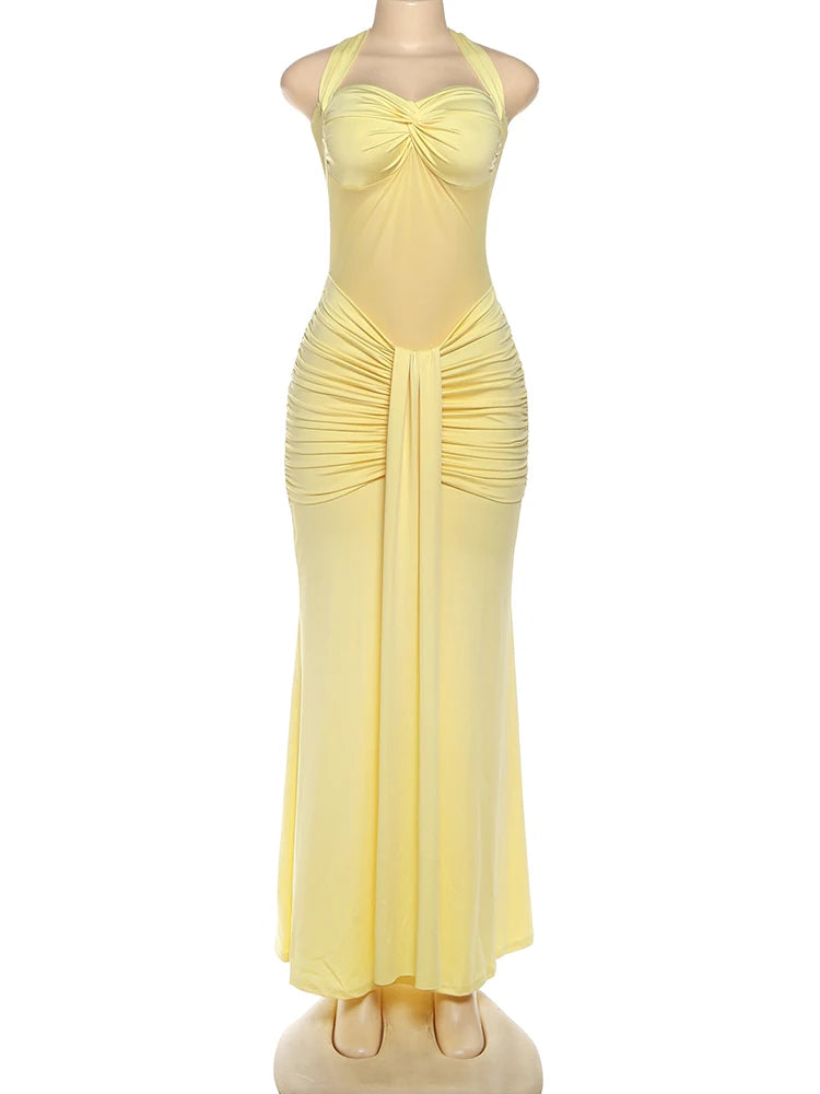 Yellow evening gown on a mannequin against a white background