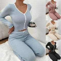 Woman wearing a light blue ribbed outfit sitting on a white rug.