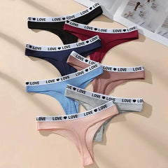 Set of women's underwear with 'LOVE' waistbands in various colors on a beige background.