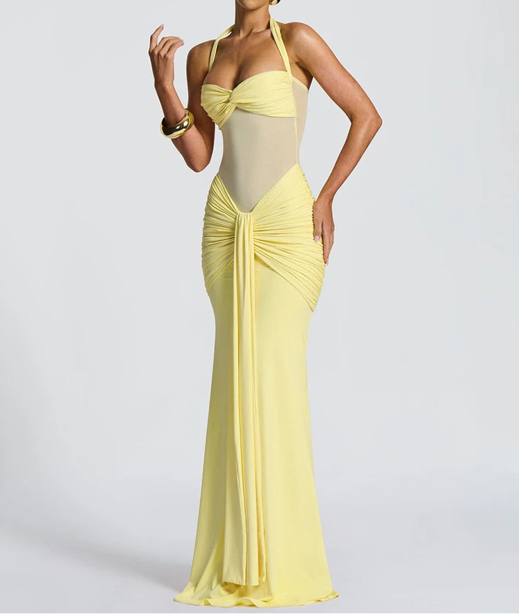 Woman wearing a yellow evening gown with a white background