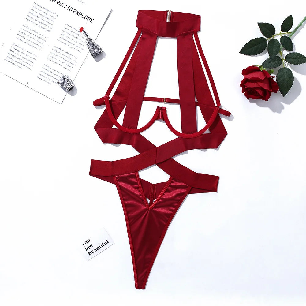 Red satin lingerie set on a white background with a magazine and rose.