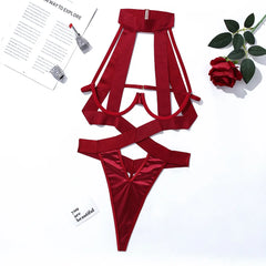 Red satin lingerie set on a white background with a magazine and rose.