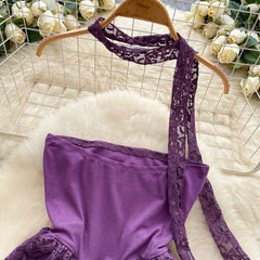 Purple lace lingerie set on a hanger with flowers in the background
